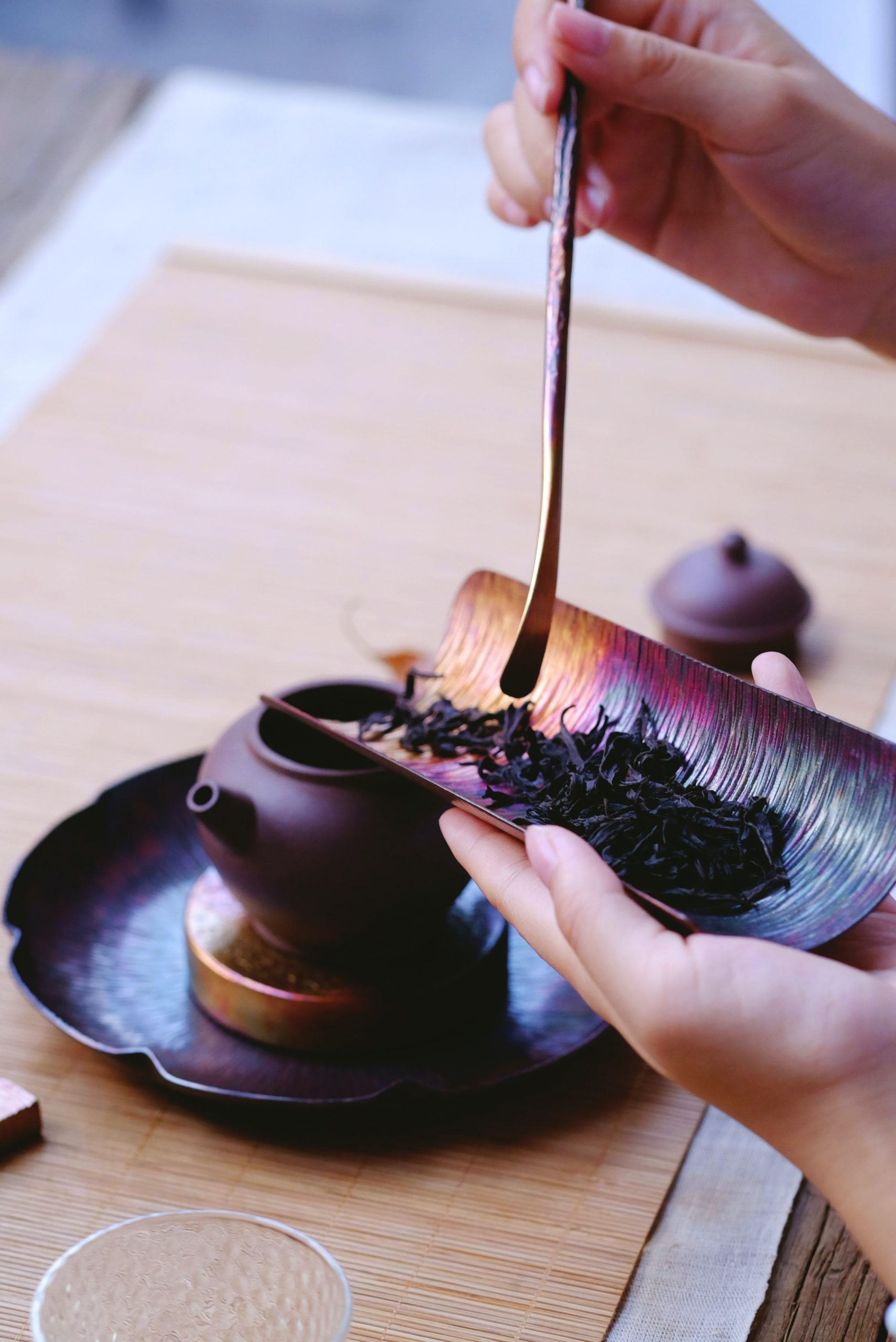 black tea being poured into chinese tea pot